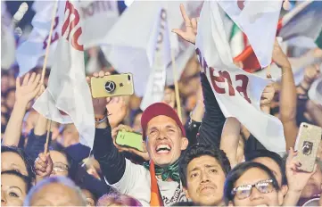  ?? — AFP photo ?? Supporters of Lopez Obrador celebrate at the Zocalo square in Mexico City, after getting the preliminar­y results of the general elections.