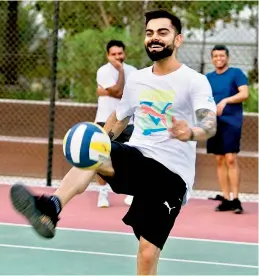  ??  ?? RCB captain Virat Kohli shares a light moment during a training session.