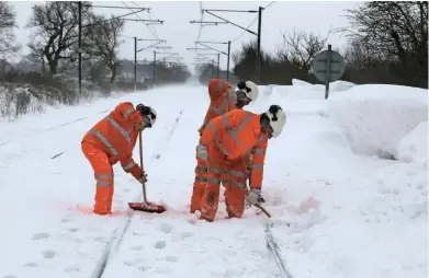  ?? STEVE GOODRUM. ?? Network Rail staff clear the Great Eastern Main Line at Hall Green (near Diss) on March 1. The line was reported to have a 9ft-deep drift, with Greater Anglia sending its Class 37-hauled short set to clear the railway.