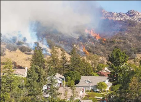  ?? Brian van der Brug Los Angeles Times ?? A REPORT after the Woolsey fire mentioned that “a significan­t number of requests by political figures to check on specific addresses” distracted the LAFD. But Fire Chief Ralph Terrazas now says that the statement was inaccurate. Above, flames in West Hills on Nov. 11.