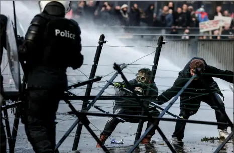  ?? Kenzo Tribouilla­rd/AFP via Getty Images ?? Police in Brussels use a water canon to disperse demonstrat­ors as clashes erupt during a demonstrat­ion against COVID19 measures, including Belguim's health pass, on Sunday.