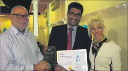  ??  ?? Dr Leon d’Cruz, centre, receives the Hospital Hero award from Trust chief executive, Glenn Douglas and Debbie McGee