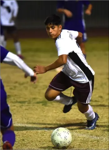  ?? PHOTO AARON BODUS ?? Calexico’s Alejandro Serrano (26) and Southwest’s Axel Castro (15) get after the ball during the second half of a 2-2 tie between the Bulldogs and Eagles in El Centro on Jan. 22. Serrano was voted boys’ Player of the Year by Imperial Valley League coaches.