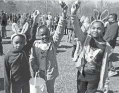  ?? ?? From left to right, sisters Machelle Woods, 6, Toya Woods, 5, and Carla Woods, 8, all from Dearborn, show off their marshmallo­ws collected during the event. Hundreds of kids came for the annual tradition, which sees them collecting marshmallo­ws to turn in for prizes.