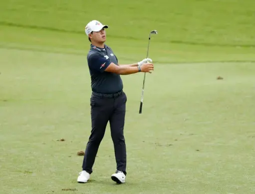  ?? Chris Keane/Getty Images ?? Si Woo Kim shot a 65 in the second round of the Wyndham Championsh­ip Friday to move him into a four-way tie for first at Sedgefield Country Club in Greensboro, N.C.