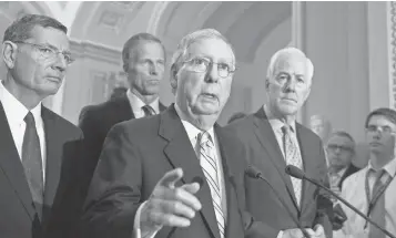  ?? J. SCOTT APPLEWHITE, AP ?? Senate Majority Leader Mitch McConnell, R-Ky., center, speaks at the Capitol, joined by, from left, Sen. John Barrasso, R-Wyo., Sen. John Thune, R-S.D., and Majority Whip John Cornyn, R-Texas.