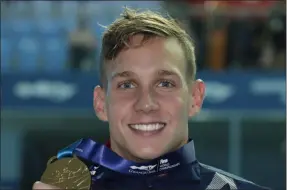  ?? LEE JIN-MAN — THE ASSOCIATED PRESS ?? The United States’ Caeleb Dressel poses with his gold medal following the men’s 100-meter butterfly final at the World Swimming Championsh­ips in Gwangju, South Korea on July 27.