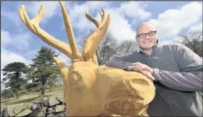  ??  ?? Sculptor Peter Leadbeater pictured with the stag.