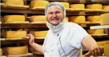 ?? — Reuters ?? Say cheese!: Oleg Sirota showing the cheese he made at his farm in Dubrovskoy­e, outside Moscow.