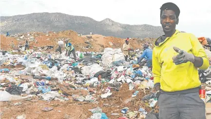  ?? Picture: BHONGO JACOB ?? BANKING ON WASTE: Songezo Zito of Ezibeleni makes a living by collecting waste at the Ezibeleni tip site for the recycling industry