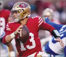  ?? ?? The Associated Press
San Francisco 49ers quarterbac­k Brock Purdy rolls out against the Dallas Cowboys during their NFL playoff game last weekend. The rookie QB faces a tougher test this weekend in hostile Philadelph­ia.