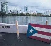  ?? CARLOS GIUSTI/AP ?? A wooden Puerto Rican flag is displayed on the dock of the Condado lagoon in San Juan, Puerto Rico.