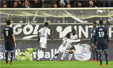  ??  ?? Amiens’ Pape Moussa Konate (third from right) reeling away after scoring against Lille on Monday. — AFP