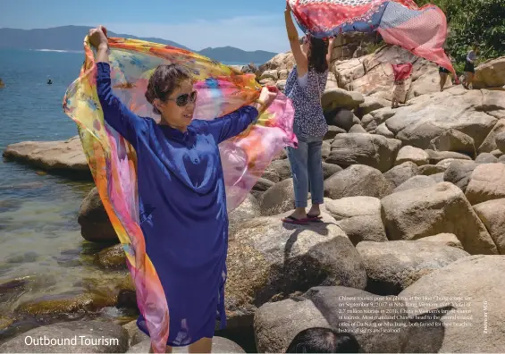  ??  ?? Chinese tourists pose for photos at the Hon Chong scenic site on September 9, 2017 in Nha Trang, Vietnam. With a total of 2.7 million tourists in 2016, China is Vietnam’s largest source of tourists. Most mainland Chinese head to the central coastal cities of Da Nang or Nha Trang, both famed for their beaches, historical sights and seafood