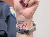  ?? JOHN MCCALL/SOUTH FLORIDA SUN SENTINEL ?? Fort Lauderdale Police Chief Karen Dietrich on Tuesday wears a tattoo on her wrist rememberin­g those killed in the massacre at Marjory Stoneman Douglas High School in 2018.