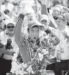  ?? Steve C. Mitchell European Pressphoto Agency ?? TAKUMA SATO takes a milk shower after taking a drink from the bottle, a tradition followed every year by winners of the Indianapol­is 500.