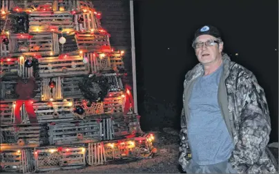  ??  ?? ADAM RANDELL/THE BEACON Stacked seven-tiers high, with 80 to 85 lobster traps and a crab pot to round out the top, Bruce Oram’s tree is estimated to be 12 feet high.