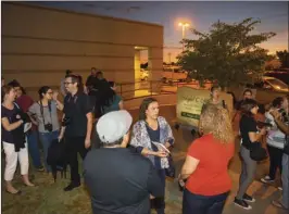  ?? OSUNA PHOTO ?? Friends, family and loved ones gather in honor of the late Miguel C. Miranda after the unveiling of a memorial boulder at Clinicas de Salud del Pueblo on Thursday night. VINCENT