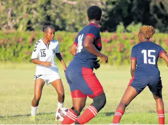  ?? PHOTO BY LENNOX ALDRED ?? Frazsiers Whip star player Shaniel Buckley (left) is watched carefully by two Royal Lakes defenders during their Jamaica Women’s Premier League match at the Royal Lakes Sports Complex on August, 2023.
