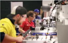  ?? Chris Whiteoak / The National ?? Participan­ts in the hairdressi­ng category, top, get busy during WorldSkill­s 2017. Abdulla Al Shehhi of the UAE, above left, focuses on his aircraft maintenanc­e while, right, the prototype modelling competitio­n progresses