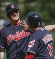  ?? RON SCHWANE — THE ASSOCIATED PRESS ?? Cleveland Indians’ Jay Bruce celebrates with Jose Ramirez ( 11) after hitting a three- run home run off Detroit Tigers starting pitcher Buck Farmer during the first inning in a baseball game, Wednesday in Cleveland.