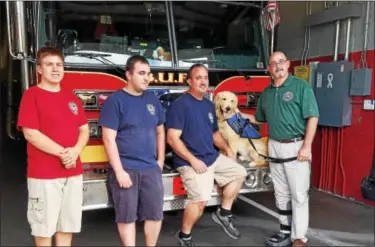  ?? DONNA ROVINS — DIGITAL FIRST MEDIA ?? Aaron Durso, Birdsboro Borough manager, right, recently took his new seizure response dog Dexter to meet members of the Birdsboro-Union Fire Department. Shown here left to right are: Sean Walter, firefighte­r junior; Shane Rhoads, firefighte­r; and Scott...