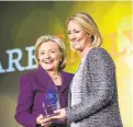  ?? Brooks Kraft / Corbis 2015 ?? Hillary Clinton with Stephanie Schriock of Emily’s List in 2015.