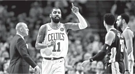  ?? AP PHOTO/CHARLES KRUPA ?? SCORE. Boston Celtics guard Kyrie Irving (11) gestures after hitting a basket during the second half of an NBA basketball game in Boston, Wednesday, Dec. 13, 2017. Irving scored 33 as the Celtics defeated the Nuggets 124-118.