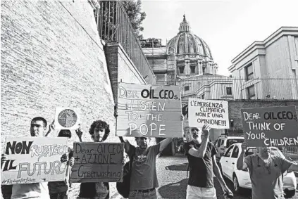  ?? CLAUDIO PERI/AP ?? Activists protest outside the Vatican as Pope Francis and oil executives meet Friday to discuss climate change.