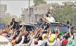  ?? SONU MEHTA/HT ?? Prime Minister Narendra Modi waves to his supporters during a road show, after inaugurati­ng the DelhiMeeru­t National expressway, in Delhi on Sunday.