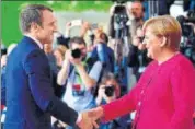  ?? AFP ?? French President Emmanuel Macron (left) is greeted by German Chancellor Angela Merkel prior to talks in Berlin on Monday.