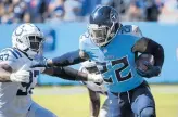  ?? JOHN AMIS/AP ?? Titans running back Derrick Henry fends off Colts defensive tackle Al-Quadin Muhammad on Sept. 26 in Nashville, Tenn.