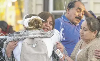  ?? TYLER PASCIAK LARIVIERE/SUN-TIMES ?? A woman hugs Julia Molina, grandmothe­r of Ariana Molina, on Monday after a vigil for the victims of a mass shooting in the 2000 block of West 52nd Street.