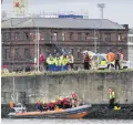  ??  ?? Emergency services at the scene of the rescue on the River Lagan