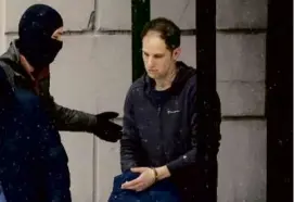  ?? ALEXANDER ZEMLIANICH­ENKO/ASSOCIATED PRESS/FILE ?? Wall Street Journal reporter Evan Gershkovic­h was escorted from court after a hearing in Moscow on Jan. 26.