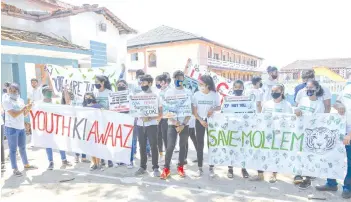  ??  ?? Young environmen­tal activists hold posters and banners outside a meeting at Altona in Goa.