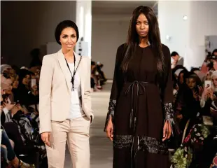  ??  ?? Sara Al-Madani of Rouge Couture, left, with a model.