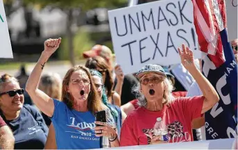  ?? Photos by Thao Nguyen / Contributo­r ?? Two women who wanted to be identified only as patriots take part in a protest in Austin against Gov. Greg Abbott’s handling of COVID-19 with a mask mandate and business closures and restrictio­ns.