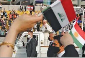  ?? (AP/Hadi Mizban) ?? Pope Francis waves to the faithful Sunday as he arrives for an open-air Mass at a stadium in Irbil, Iraq.