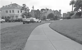  ??  ?? A sidewalk leads to luxury homes in the Presidio Terrace neighborho­od where an investor has purchased the street, sidewalks and other common areas in the private developmen­t.