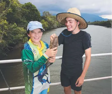  ?? Picture: ANNA ROGERS ?? TOP CATCH: Luka Ormond, 14, and Ash Ewing, 14, are happy with the flathead they caught in the Barron River at Stratford. The region’s waterways have been graded in a report.