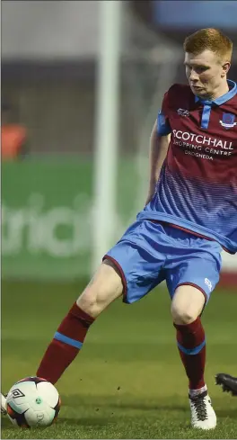  ??  ?? Mark Doyle of Drogheda United holds the ball up as Danny Devine closes