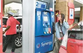  ?? KENNETH K. LAM/BALTIMORE SUN ?? Leora Match, of Baltimore, fills up her hybrid vehicle in April, just before Maryland’s temporary gas tax holiday expired. Since then inflation has driven prices at the pump to new highs.