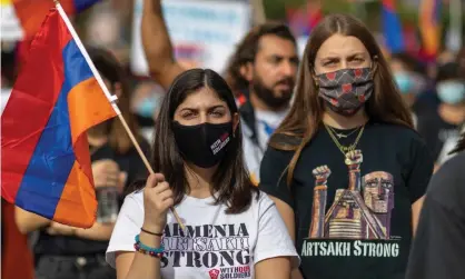  ??  ?? Armenians and supporters march to the Azerbaijan­i consulate general offices in Los Angeles on 1 November, in protest of the conflict in Artsakh. Photograph: David McNew/Getty Images