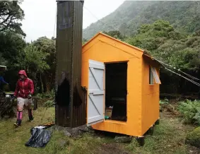  ??  ?? ABOVE TOP / Building a mountain bike trail, Craigiebur­n. ABOVE BOTTOM / West Mathias Biv has been recently painted and a woodshed and toilet added.
PREVIOUS PAGE / Members of the Canterbury Mountainee­ring Club are pictured working on Barker Hut.