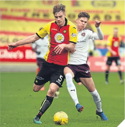  ??  ?? ■ Partick Thistle’s Liam Lindsay holds off a challenge from Hearts’ Rory Currie.