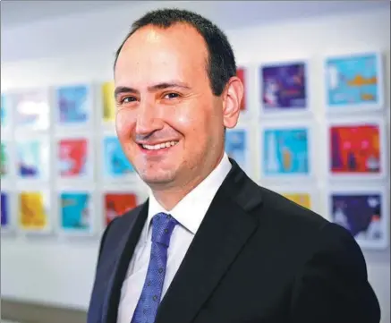  ?? REUTERS ?? Cem Karakas, CEO of Pladis Group, smiles as he poses for a portrait at his company's headquarte­rs in London.