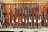  ?? ASSOCIATED PRESS FILE PHOTO ?? Rifles are displayed at Firing-Line gun store in Aurora, Colo.