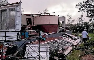 ??  ?? A homeowner surveys the damage to his house from Cyclone Gita in Tonga. Authoritie­s believe thousands of families have lost their homes in the storm.