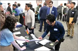  ?? ?? Job seekers network at a job fair for aerospace workers in Long Beach on Friday.